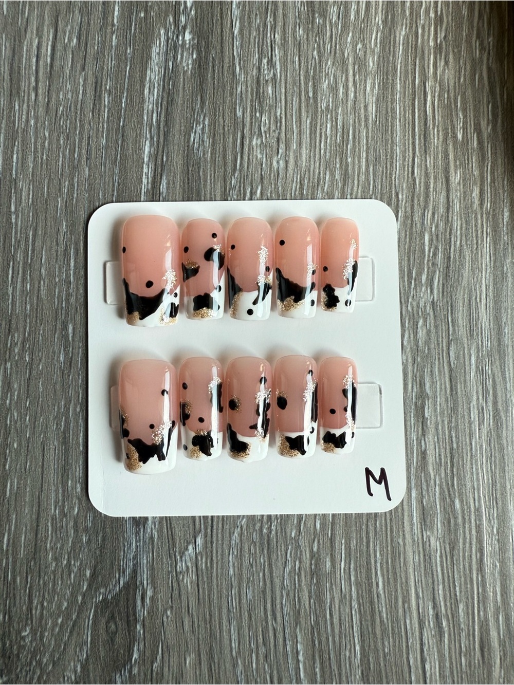 Nude Pink Cow Print Press-On Nails with Black and Gold Accents